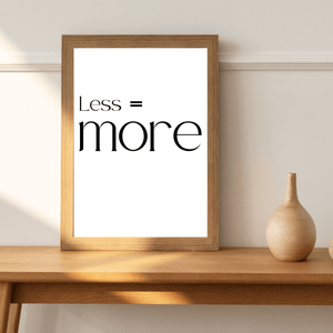 Front view of wall art featuring the quote 'Less is more' in elegant typography of a living room mockup