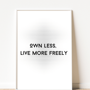  Front view of wall art featuring the quote 'Own less, live more' in elegant typography