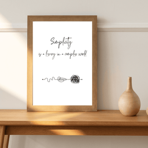 Artistic representation of the quote ' Simplicity is a luxury in a complex world' in a decorative wall print, ideal for inspiration in a bed room mockup